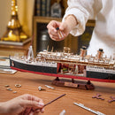 Two people are building the Robotime 1912 - Eternal Atlantic Voyager together