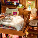 The loft with bed and decorations in the Robotime A-Frame Cabin