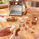 Two people are building the Robotime Baking Kitchen together