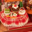 The table laden with Christmas treats in the Robotime Christmas Eve Party