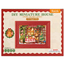 Front of package of the Robotime Christmas Eve Party, diorama of a Christmas themed living room with lights