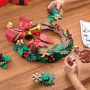 A person is building the Robotime Christmas Wreath