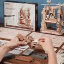 A person is building the Robotime Classic Printing Press