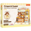 Front of package of the Robotime Cookii Bunny’s Cookie Shop, miniature cookie shop with Cookii Bunny behind the counter