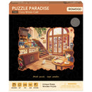 Front of package of the Robotime Cozy Winter Café, wooden puzzle of a café in winter with unusual pieces