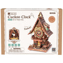 Front of package of the Robotime Cuckoo Clock, wooden construction set of a cuckoo clock with Alice in Wonderland theme