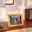 Atmospheric presentation of the Robotime Daily Fresh Flower, diorama in a frame of an old-fashioned shop with flowers and plants