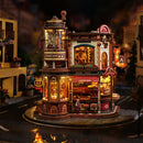An atmospheric display of the Robotime Dream Coffee Factory, in the dark with the lights on