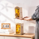 A person stacking two book nooks in Robotime Dust Covers WD1001 on top of each other