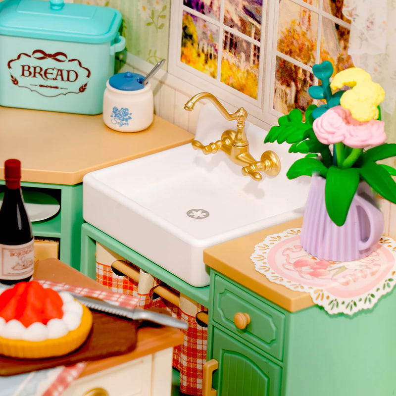 Sink in the kitchen countertop with kitchen utensils and a vase of flowers in the Robotime Farmhouse Kitchen