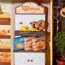 Pre-packaged bread and pastries in a cabinet from the Robotime Fluffy Cat Bakery