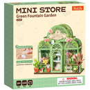 Front of package of the Robotime Green Fountain Garden, construction kit for a miniature flower shop in an elegant greenhouse