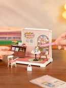 A person is building the Robotime Honey Tea Lounge