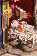 Detail of a table with tea and some pastries of the Robotime Leisure Time Tea Room