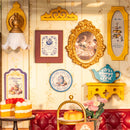 Framed photos and wall decorations on the wall of the Robotime Leisure Time Tea Room