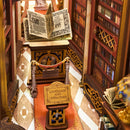 The open book next to the plaque on a pedestal between tall bookcases in the Robotime Library of Wonders