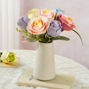 The Robotime Light Pink Camellia in a bouquet with other plastic flowers from the ROKR Floral Art series
