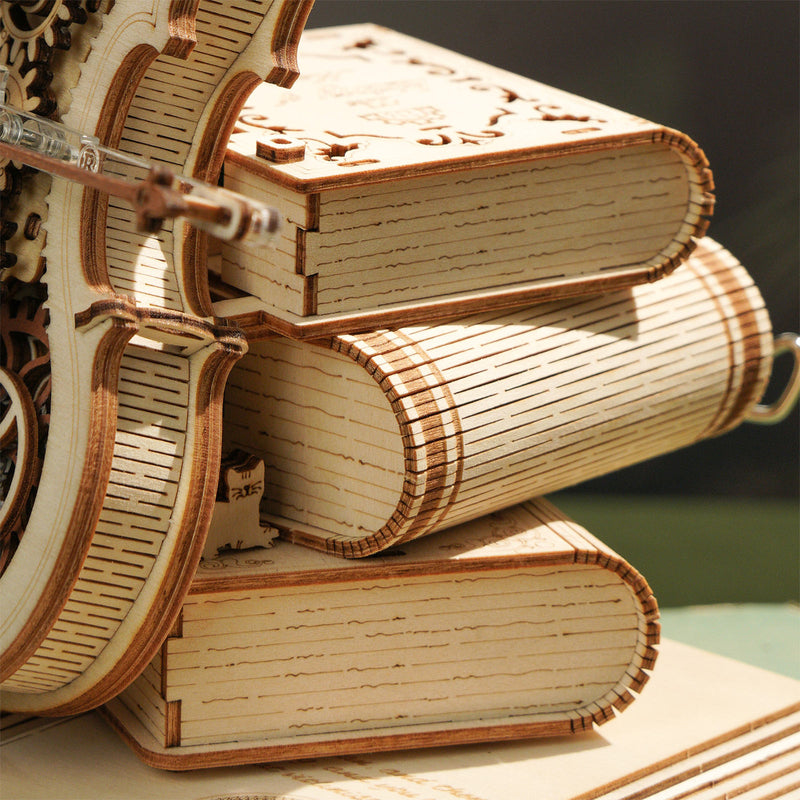 Three books against which the Robotime Magic Cello leans