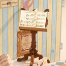 Music stand with sheet music in the Robotime Melody Instrument Shop