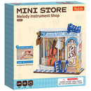 Front of package of the Robotime Front of package of the Robotime Melody Instrument Shop, construction kit for a miniature house of a music store