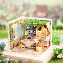 Atmospheric presentation of the Robotime Midsummer Dream Yard, plastic miniature terrace with set table, pergola, and furniture