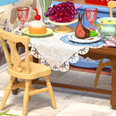 Table set with grapes, meat, and pastry in the Robotime Midsummer Dream Yard