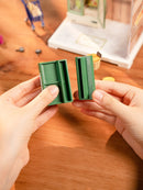 A person building a cabinet of the Robotime Nature Energy Fruits