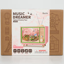 Front of package of the Robotime Sakura Dreamy Tour, wooden construction set of a small tv with a tram car inside