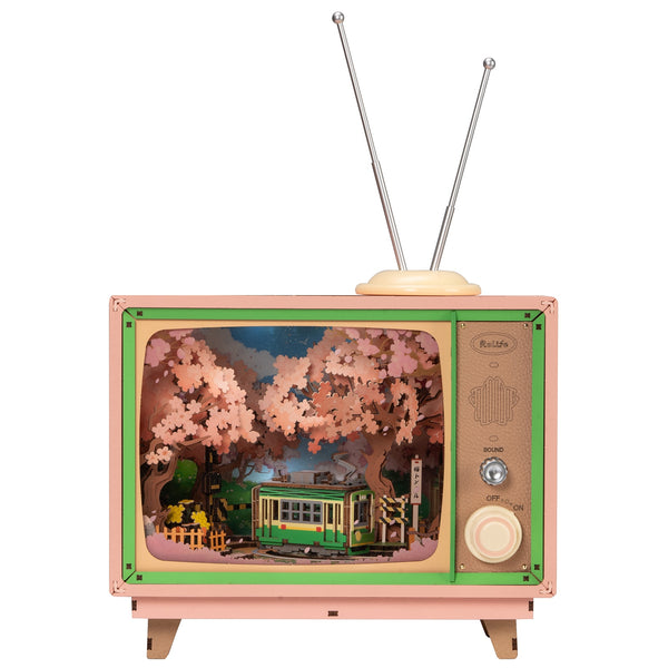 Product photo of the Robotime Sakura Dreamy Tour, wooden construction set of a small tv with a tram car inside