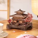 Atmospheric presentation of the Robotime Sakura Pavilion, wooden construction kit for a Japanese pavilion with cherry blossom trees on both sides of the building