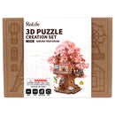 Front of package of the Robotime Sakura Tree House, wooden construction set of a tree house in a Japanese cherry blossom tree