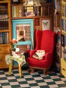 Close-up of the chair and table and loaded bookshelves in the Robotime Sam’s Study