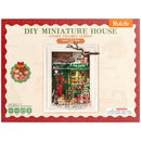 Front of package of the Robotime Santa’s Toy Shop, diorama of a Christmas themed store with lights