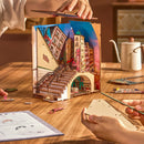 Two people are building the Robotime Street Scene book nook