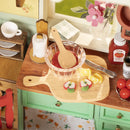 Sliced fruit and a large bowl of jam being prepared in the Robotime Sunlit Farmhouse Kitchen
