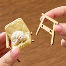 A person is assembling the chair of the Robotime Sunset Isle