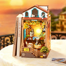 The Robotime Sunset Isle on a table with a sunset in the background