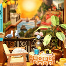 The balcony with a small table and chair from the Robotime Sunset Isle set, with the sunset in the background