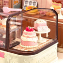 Close-up of two cakes in the display case of the Robotime Tasty Cake Shop