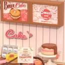 Details of advertising, a cake and props in the Robotime Tasty Cake Shop