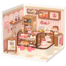 Product photo of the Robotime Tasty Cake Shop, plastic miniature house of a cute, pink cake shop