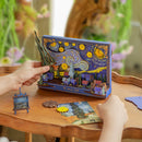 A person builds the final section of Robotime The Starry Night