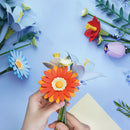 A person is building the Robotime Twilight Sky Bouquet