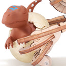 The freshly hatched dinosaur, still in its egg, in the claws of the Robotime Velociraptor