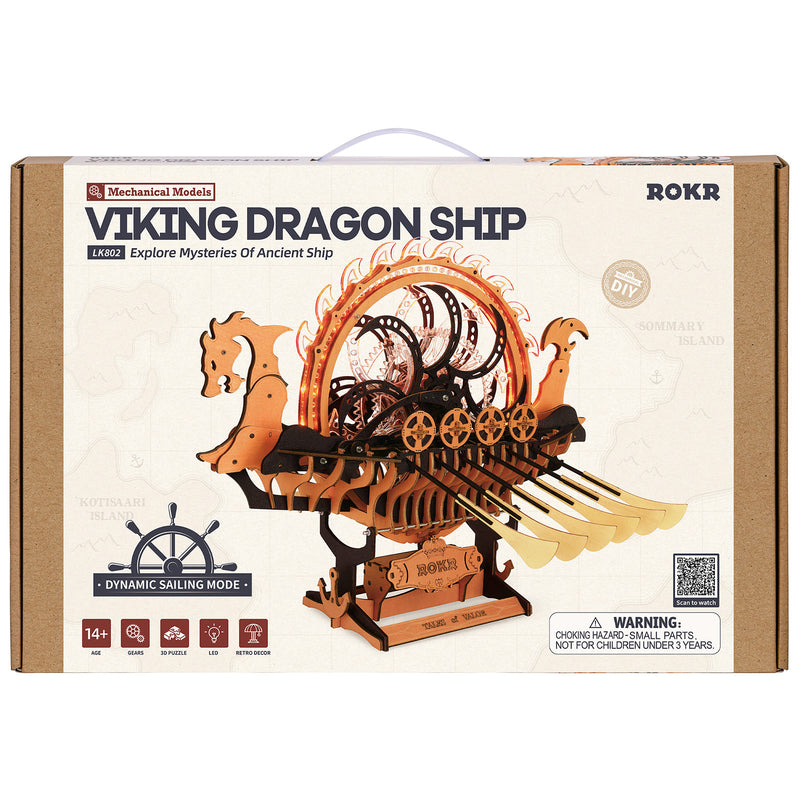 Front of package of the Robotime Viking Dragon Ship, wooden construction set of a Viking ship with moving oars and an illuminated wheel on the deck