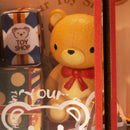 The large teddy bear in the shop window of the Robotime Whimsy Toy Shop