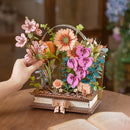 A person places the last flower in the Robotime Wooden Blooming Book