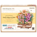 Front of package of the Robotime Wooden Blooming Book, wooden construction kit of a bouquet of flowers on a closed book