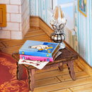 A stack of Moomin books on a small table in the Rolife Moominhouse