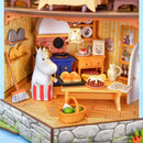 Moominmamma is baking rolls in the little kitchen of the Rolife Moominhouse